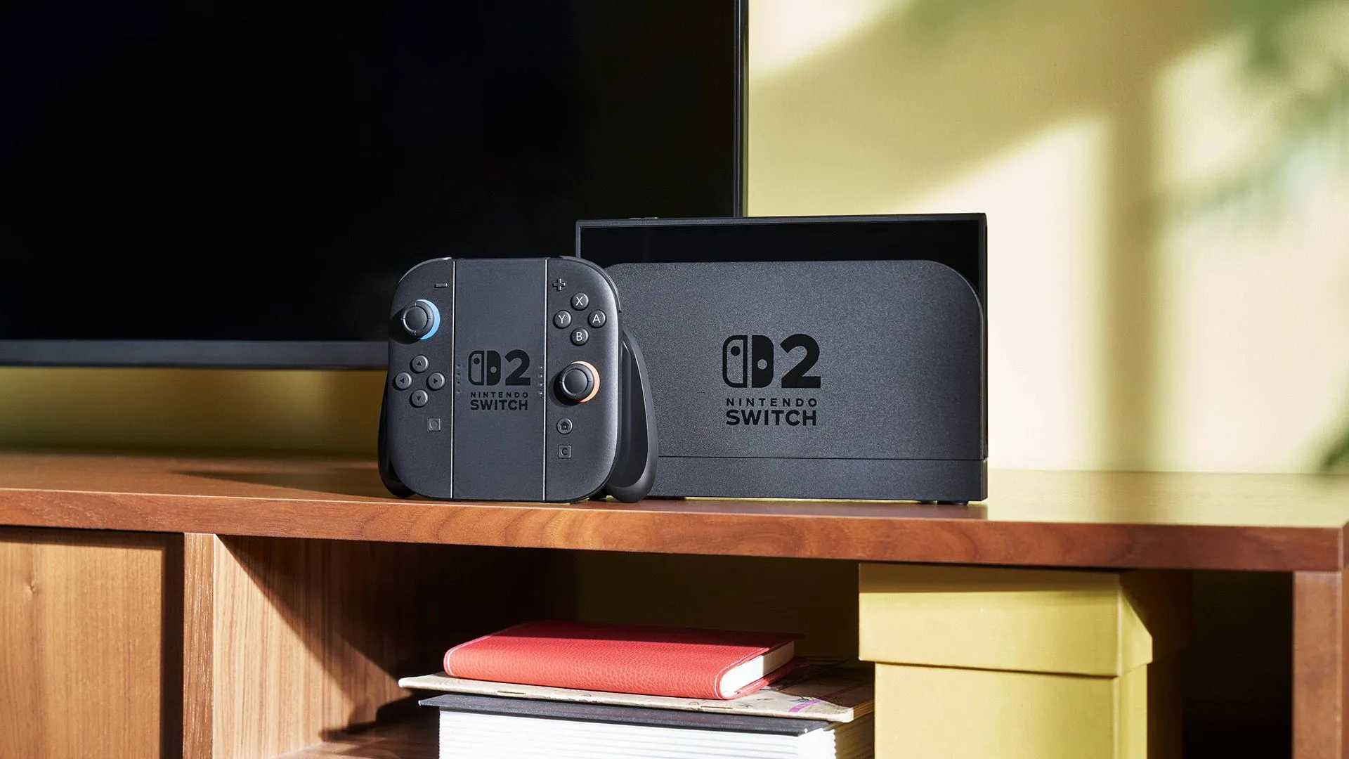 Console Nintendo Switch 2 được kết nối với TV và tay cầm Joy-Con đang gắn trên máy