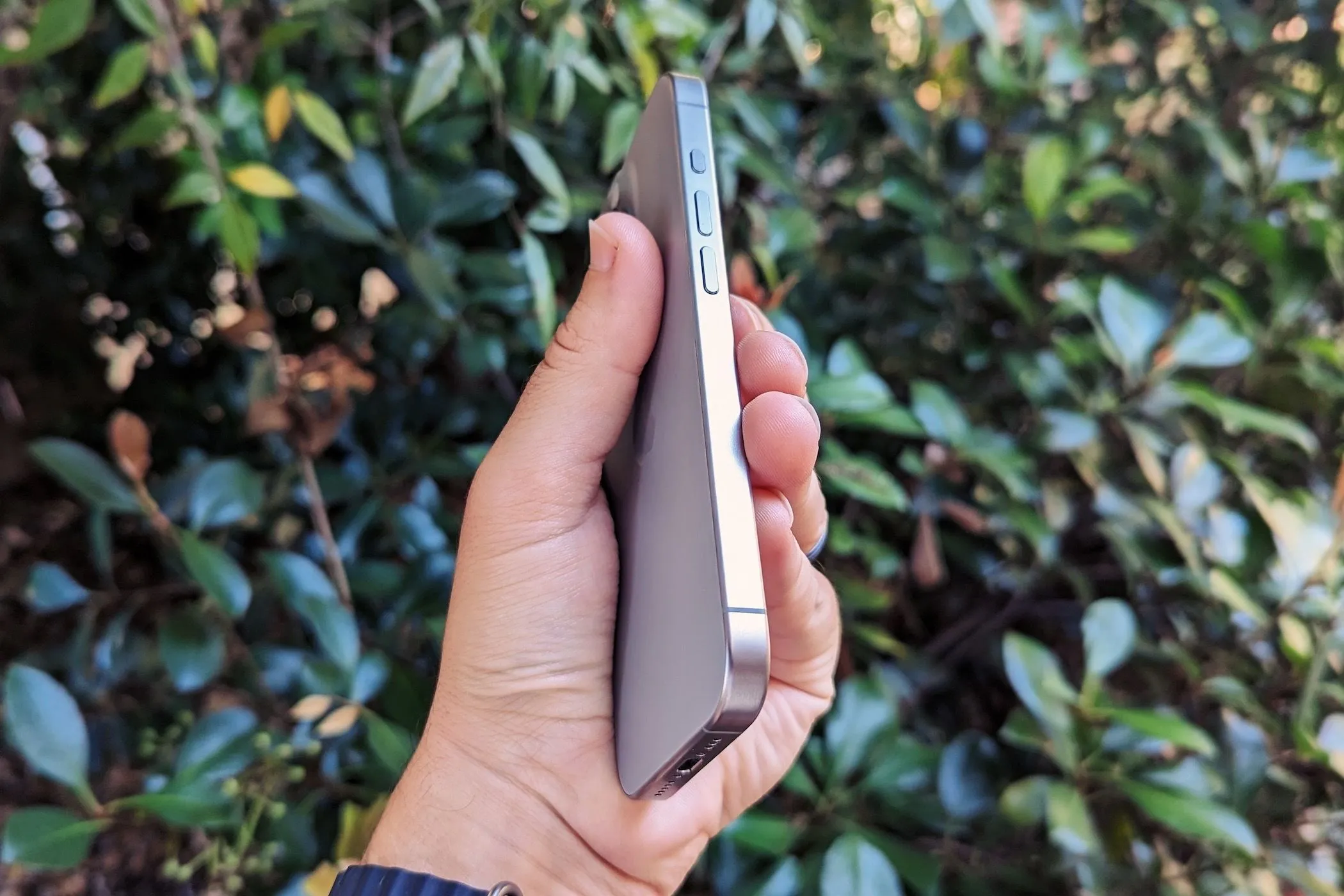 Một người đang cầm iPhone 15 Pro, sử dụng các ứng dụng sức khỏe.