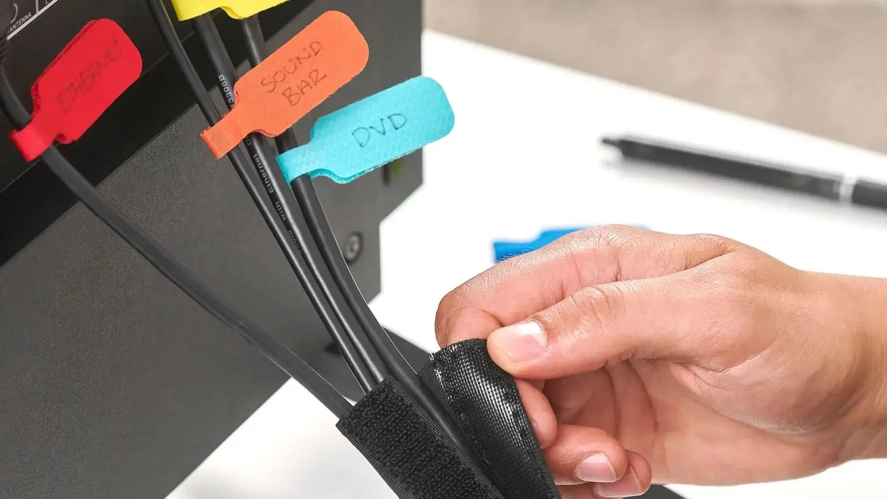 Một bộ cáp rạp hát gia đình được sắp xếp gọn gàng bằng nhãn dán và dây buộc Velcro, cho thấy cách quản lý cáp hiệu quả