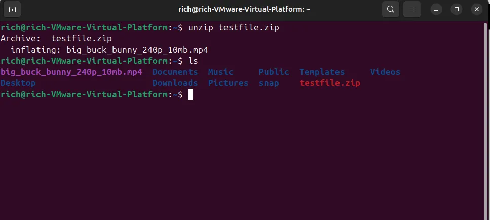 Terminal Linux hiển thị lệnh unzip testfile.zip đang giải nén một tệp video, sau đó là lệnh ls liệt kê tệp MP4 đã giải nén và file ZIP gốc