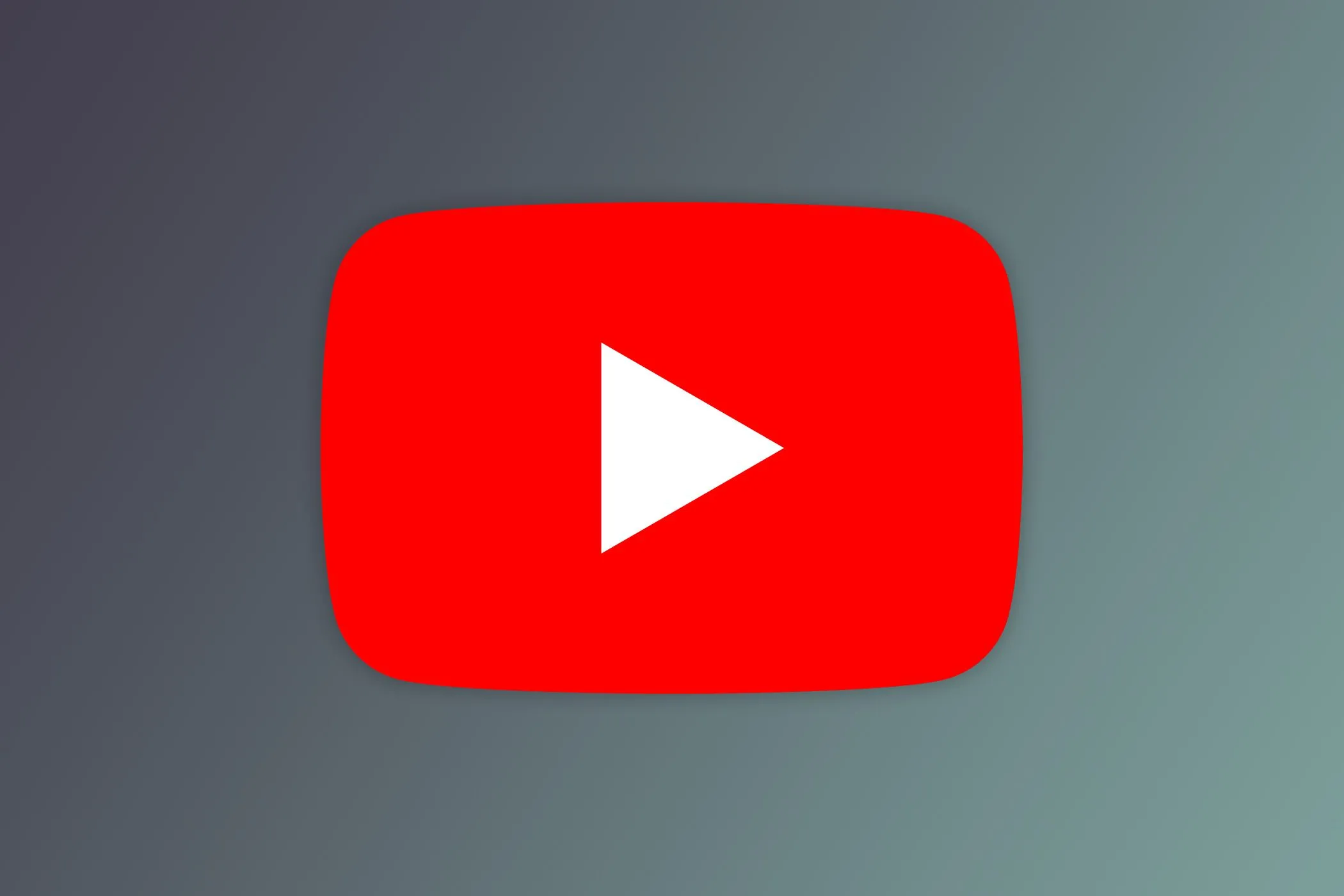 Logo YouTube trên màn hình với nền mờ các video