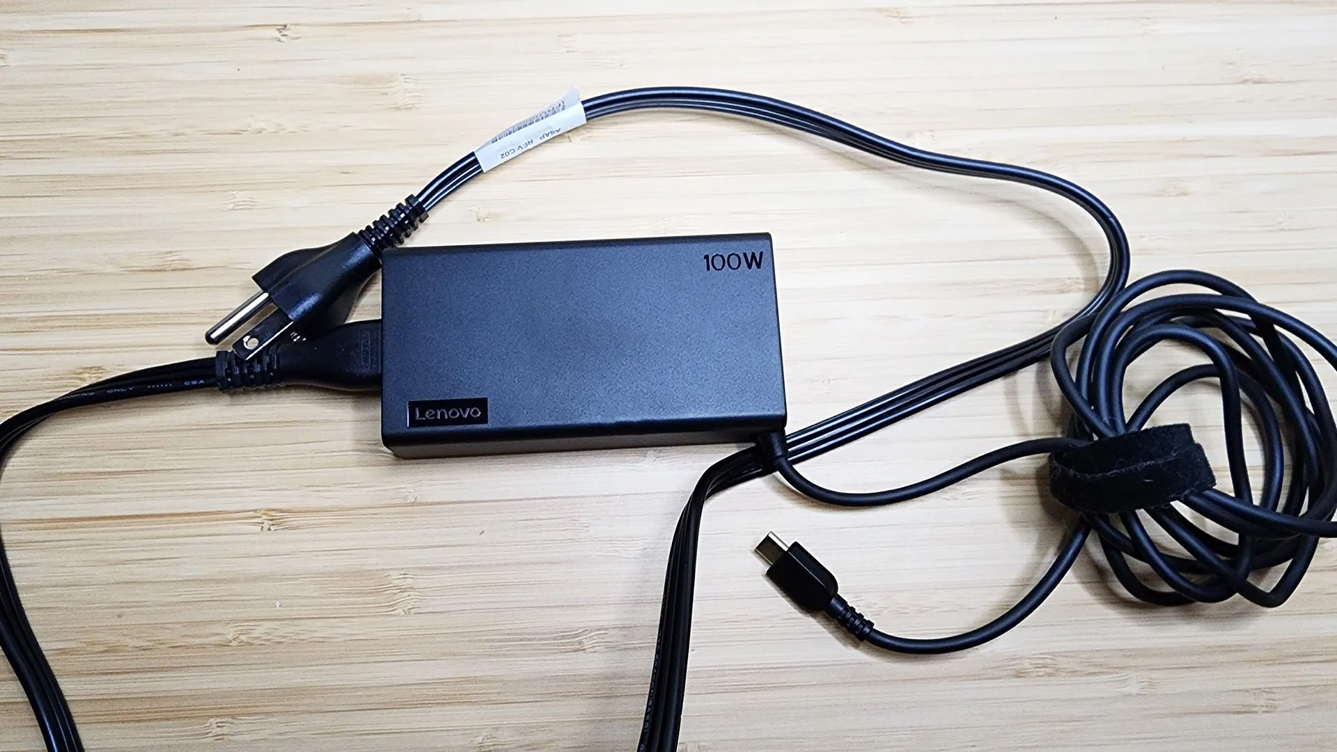 Chiếc laptop Lenovo Yoga 9i Gen 8 màu xám bạc đang mở, thể hiện thiết kế hiện đại và nhu cầu sử dụng sạc chính hãng.