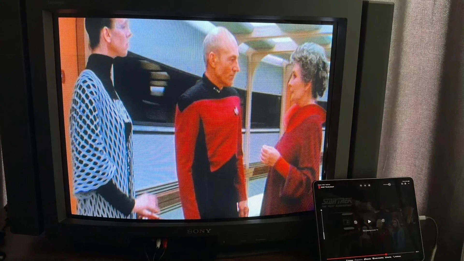 Màn hình cũ hiển thị phim Star Trek được phát trực tiếp từ iPad, tạo thành một trung tâm giải trí thu nhỏ.